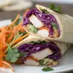 A close-up cross-section of a Gluten-Free Chicken Wrap showing the colorful layers.