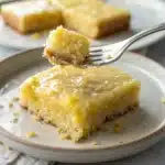 a bite taken out of a gluten free lemon brownie.