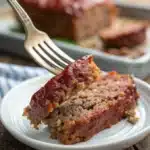 A slice of juicy gluten free meatloaf on a fork.