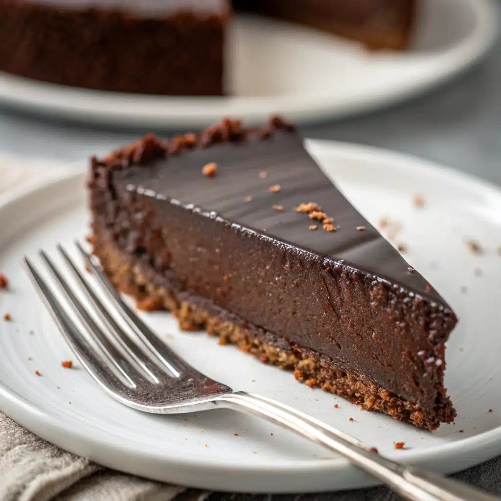 A close-up slice of rich vegan chocolate torte.