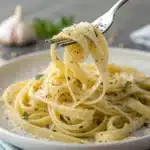 A close-up forkful of cooked fresh gluten-free pasta.