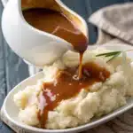 A boat of homemade gluten free gravy on a holiday table.